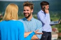 Couple having fun while busy businessman speak on phone. Couple happy flirting while man tense with mobile conversation