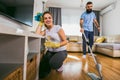 Couple having fun while doing spring cleaning Royalty Free Stock Photo