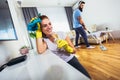 Couple having fun while doing spring cleaning together