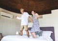 Couple having fun jumping on the bed Royalty Free Stock Photo