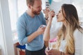 Couple having fun and laughing at home while eating ice cream Royalty Free Stock Photo