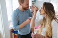 Couple having fun and laughing at home while eating ice cream Royalty Free Stock Photo