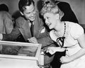 Couple having fun and laughing next to a pinball machine Royalty Free Stock Photo