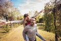 Couple having fun man giving piggyback to woman in park Royalty Free Stock Photo