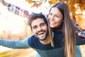 Couple having fun man giving piggyback to woman in park Royalty Free Stock Photo