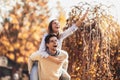 Couple having fun man giving piggyback to woman in park Royalty Free Stock Photo