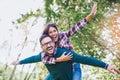 Couple having fun man giving piggyback to woman in park Royalty Free Stock Photo