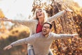 Couple having fun man giving piggyback to woman in park Royalty Free Stock Photo