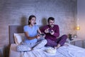 Couple having fun playing video games in bed Royalty Free Stock Photo