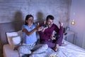 Couple having fun playing video games in bed Royalty Free Stock Photo