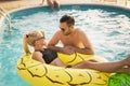 Couple having fun at a poolside party Royalty Free Stock Photo