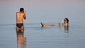 Couple having fun in Dead sea, Israel