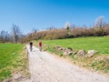 Couple having fun by riding mountain bike on dirt road in sunny day, scenic landscape of snowcapped mountain range. Man and woman Royalty Free Stock Photo