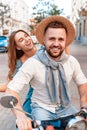 Couple having fun riding scooter in old European city Royalty Free Stock Photo