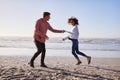 Couple Having Fun Running Along Winter Beach Together Royalty Free Stock Photo