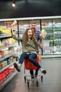 Couple having fun with the shopping cart in the supermarket Royalty Free Stock Photo