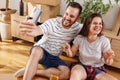 Couple having fun taking selfies with their new apartment keys while moving in together Royalty Free Stock Photo