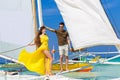 Couple having fun on tropical beach on the sailboat. Summer vacation concept. Royalty Free Stock Photo