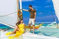 Couple having fun on tropical beach on the sailboat. Summer vacation concept. Royalty Free Stock Photo