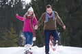 Couple having fun and walking in snow shoes Royalty Free Stock Photo