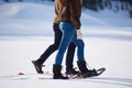 Couple having fun and walking in snow shoes