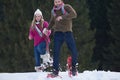 Couple having fun and walking in snow shoes Royalty Free Stock Photo