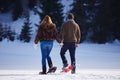 Couple having fun and walking in snow shoes Royalty Free Stock Photo