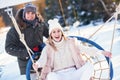 Couple having fun in winter snow on swing Royalty Free Stock Photo