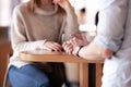 Couple having a meeting at a cafe bar. Abstract shot of hands