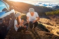 Couple having picnic near the car Royalty Free Stock Photo