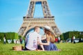 Couple having picnic near the Eiffel tower in Paris, France Royalty Free Stock Photo