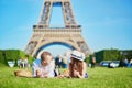 Couple having picnic near the Eiffel tower in Paris, France Royalty Free Stock Photo