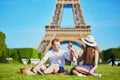 Couple having picnic near the Eiffel tower in Paris, France Royalty Free Stock Photo