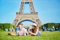 Couple having picnic near the Eiffel tower in Paris, France Royalty Free Stock Photo