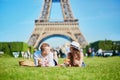 Couple having picnic near the Eiffel tower in Paris, France Royalty Free Stock Photo