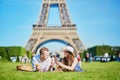 Couple having picnic near the Eiffel tower in Paris, France Royalty Free Stock Photo