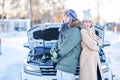 Couple having problem with the car during winter trip Royalty Free Stock Photo