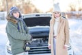 Couple having problem with the car during winter trip Royalty Free Stock Photo