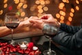 A couple having a romantic dinner and a suprise proposal in a elegance restaurant with beautiful decoration. Romance and Royalty Free Stock Photo