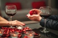 A couple having a romantic dinner and a suprise proposal in a elegance restaurant with beautiful decoration. Romance and Royalty Free Stock Photo