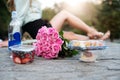 Couple having romantic picnic date in the park with food, drinks and flower