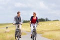 Couple having sea coast bicycle tour at levee