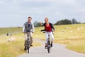 Couple having sea coast bicycle tour at levee Royalty Free Stock Photo
