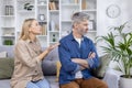 Couple having a serious discussion on the couch at home Royalty Free Stock Photo