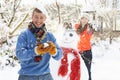 Couple Having Snowball Fight In Garden Royalty Free Stock Photo