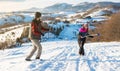 Couple having sword fight with hiking canes Royalty Free Stock Photo