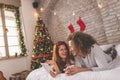 Couple having video call with friends on Christmas morning Royalty Free Stock Photo