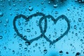 Couple heart draw on water drops glass window Royalty Free Stock Photo