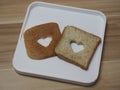 Couple Heart shaped on Whole Wheat Bread put on white tray, background love Valentine Day Royalty Free Stock Photo
