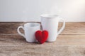 Couple Hearts and Couple coffee cups on wooden table